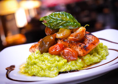 Grilled Norwegian Salmon creamy pesto risotto, confit Heirloom cherry, tomatoes and fried Basil