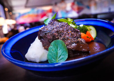 8oz USDA Prime Flat Iron Steak roasted garlic mashed potatoes, vegetable medley, sauteed mushrooms and demi-glace