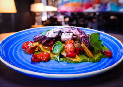 Grilled Spanish Octopus basil pesto, crispy fingerling potatoes, blistered fresno chilis, cherry tomatoes, california olive oil and charred lemon